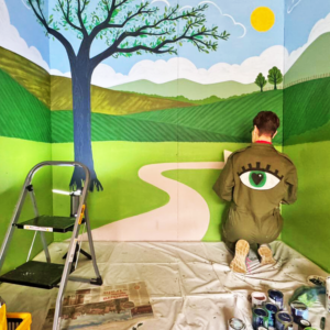 Mural inside a storage container showing a landscape with trees and rolling hills English countryside landscape mural